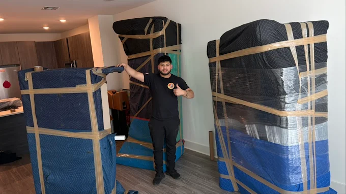 Speedy mover with carefully wrapped furniture in a customer's apartment
